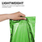 Hand holding a green lightweight self-seal mailing bag used for postage and courier packaging.